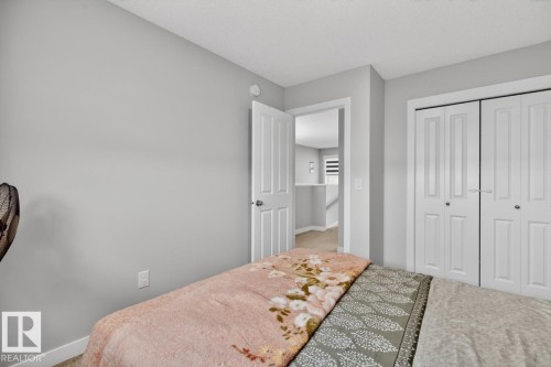 Room featuring light gray walls, white trim, and neutral carpeting - 3214 9 Street, Edmonton, AB - Indoor Photo Showing Bedroom