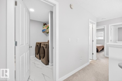 Dedicated laundry area featuring a white door, recessed lighting, and white flooring - 3214 9 Street, Edmonton, AB - Indoor Photo Showing Laundry Room