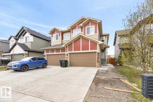 Modern multi-level exterior with red and beige siding, a double garage, and a front entryway with concrete steps - 3214 9 Street, Edmonton, AB - Outdoor With Facade