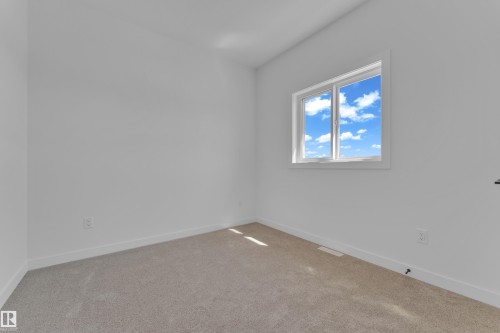 Carpeted room featuring a double-pane window with white trim, white walls, and white baseboards - 171 Graybriar Drive, Stony Plain, AB - Indoor Photo Showing Other Room