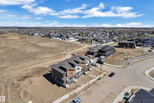Modern multi-unit property featuring dark gray and light gray siding with natural wood accents - 171 Graybriar Drive, Stony Plain, AB - Outdoor With View