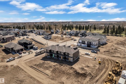 Modern residential development featuring single-family homes and townhomes with contemporary exteriors, dark roofs, and light-colored siding accents - 171 Graybriar Drive, Stony Plain, AB - Outdoor With View