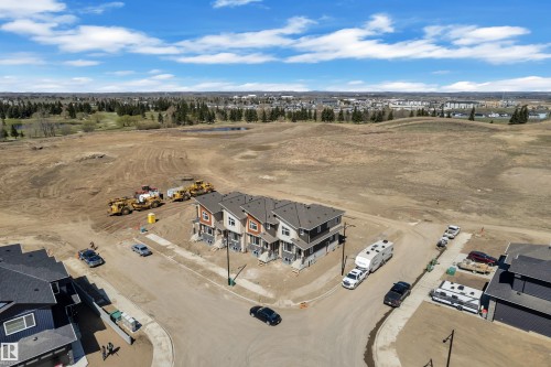 Newly constructed multi-unit dwellings featuring contemporary architecture, dark grey roofing, and light-toned siding with contrasting trim - 171 Graybriar Drive, Stony Plain, AB - Outdoor With View
