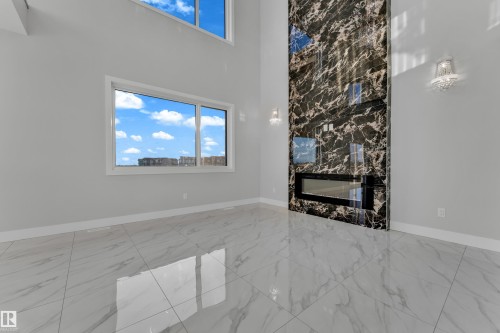 213 Crystal Creek, Leduc, AB - Indoor Photo Showing Other Room With Fireplace
