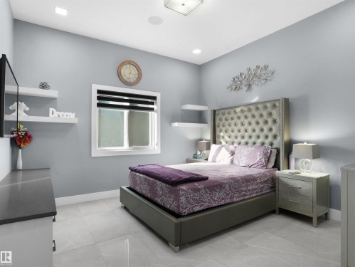 Spacious room featuring light-toned walls, recessed lighting, a window with horizontal blinds, and large format tile flooring - 913 Wood Place, Edmonton, AB - Indoor Photo Showing Bedroom