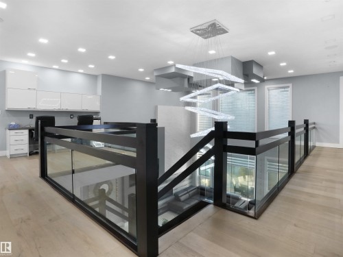 Open upper-level space featuring a contemporary chandelier, recessed lighting, and wood-finish flooring - 913 Wood Place, Edmonton, AB - Indoor