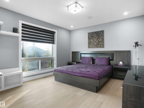 Light wood-finish flooring complements the neutral wall color - 913 Wood Place, Edmonton, AB - Indoor Photo Showing Bedroom