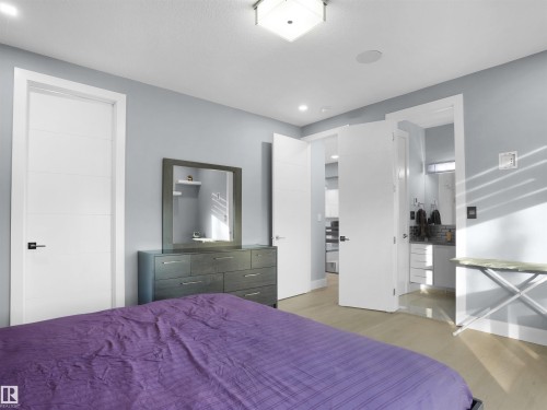 Interior space featuring light-toned wood-finish flooring and light blue walls - 913 Wood Place, Edmonton, AB - Indoor Photo Showing Bedroom