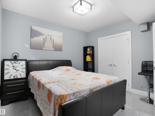 Bedroom featuring light gray walls, white trim, and a flush-mount ceiling fixture - 913 Wood Place, Edmonton, AB - Indoor Photo Showing Bedroom