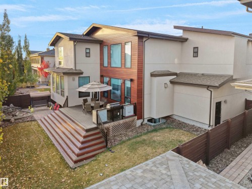 Modern exterior with mixed material siding, featuring expansive windows and a multi-level deck - 913 Wood Place, Edmonton, AB - Outdoor With Deck Patio Veranda With Exterior
