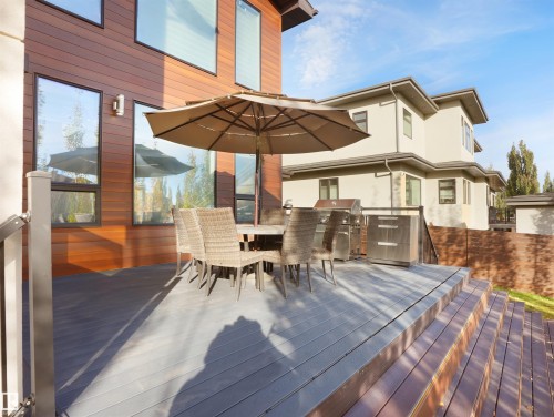 Expansive multi-level deck featuring composite decking, integrated railing, and an outdoor cooking station - 913 Wood Place, Edmonton, AB - Outdoor With Deck Patio Veranda