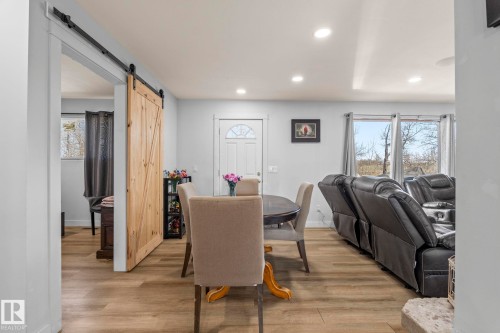 Open-concept living area featuring wood-finish flooring, recessed lighting, and light gray wall tones - 23133 Twp Rd 502, Rural Leduc County, AB - Indoor