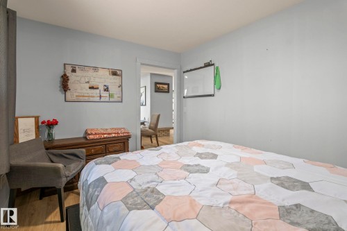 Bedroom featuring light blue walls and wood-finish flooring - 23133 Twp Rd 502, Rural Leduc County, AB - Indoor Photo Showing Bedroom