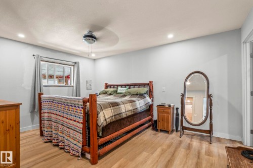 Spacious room featuring wood-finish flooring, recessed lighting, and a ceiling fan - 23133 Twp Rd 502, Rural Leduc County, AB - Indoor Photo Showing Bedroom