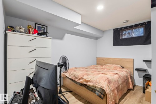 Bedroom featuring light-toned wood-finish flooring, recessed lighting, and a window with a light-blocking curtain - 23133 Twp Rd 502, Rural Leduc County, AB - Indoor Photo Showing Bedroom