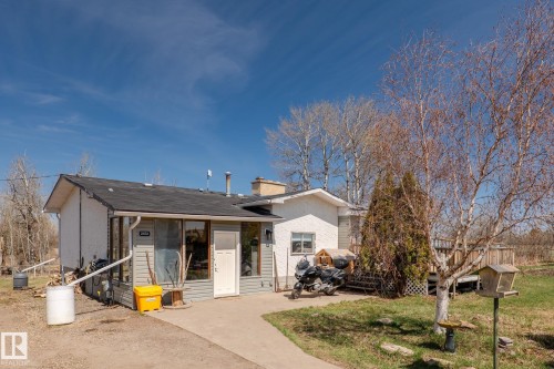 Single-story residence featuring a gray siding exterior and a dark shingle roof - 23133 Twp Rd 502, Rural Leduc County, AB - Outdoor