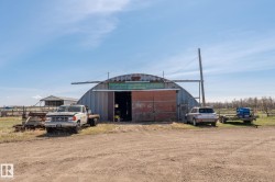 Quonset-style agricultural building featuring a corrugated metal exterior - 