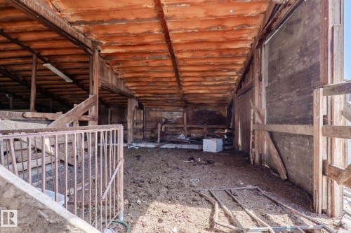 Expansive barn interior featuring exposed wood beam construction, a concrete floor, and natural light - 23133 Twp Rd 502, Rural Leduc County, AB - Indoor Photo Showing Other Room
