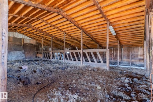 Agricultural building featuring exposed timber framing and wood plank ceiling - 23133 Twp Rd 502, Rural Leduc County, AB - 