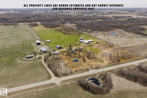 Expansive rural property featuring multiple outbuildings, open fields, and wooded areas - 23133 Twp Rd 502, Rural Leduc County, AB - Outdoor With View