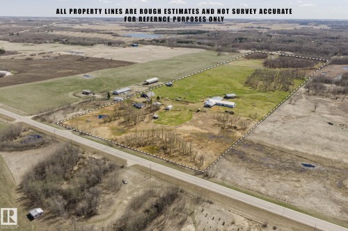 Expansive land parcel featuring multiple outbuildings, open fields, and treed areas - 23133 Twp Rd 502, Rural Leduc County, AB - Outdoor With View