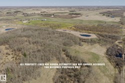 Expansive rural landscape featuring a mix of cleared land and wooded areas - 