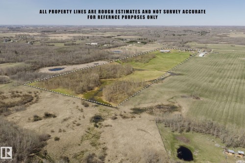 Expansive rural property featuring a mix of open fields, wooded areas, and natural ponds - 23133 Twp Rd 502, Rural Leduc County, AB - Outdoor With View