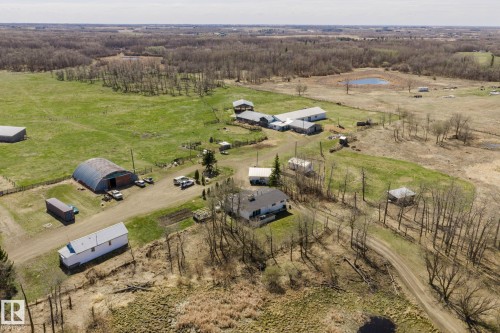 Expansive rural property featuring multiple outbuildings, open fields, and wooded areas - 23133 Twp Rd 502, Rural Leduc County, AB - Outdoor With View