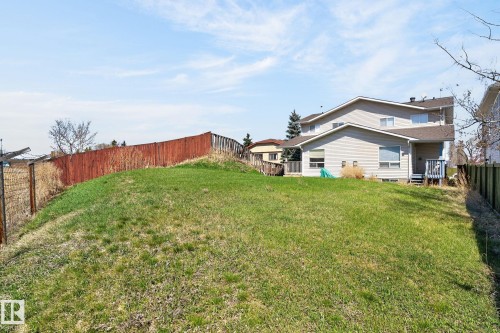 Expansive green space featuring a sloped lawn and perimeter fencing - 4603 126 Avenue, Edmonton, AB - Outdoor