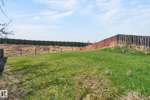 Expansive grassy area with a partial privacy fence - 4603 126 Avenue, Edmonton, AB - Outdoor