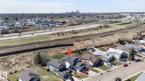 Aerial perspective showcasing a residential property with a dark grey roof and attached garage - 4603 126 Avenue, Edmonton, AB - Outdoor With View