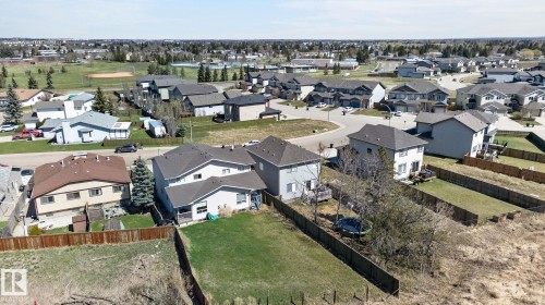 Aerial perspective showcasing a residential neighborhood with detached homes, mature trees, and a distant recreational field - 4603 126 Avenue, Edmonton, AB - Outdoor With View