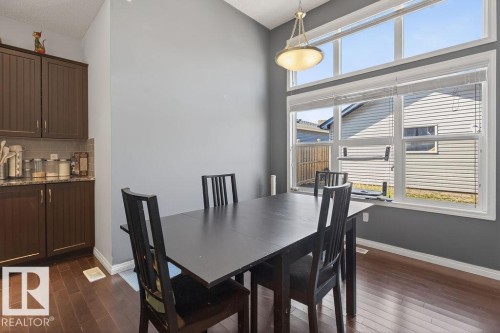 Dining area with expansive window featuring transom detailing - 17540 58 Street Nw, Edmonton, AB 