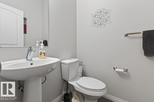 Pedestal sink with chrome faucet and framed mirror - 17540 58 Street Nw, Edmonton, AB 