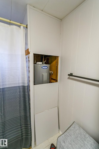 Utility closet with a visible water heater and accessible plumbing - 331 60417 Range Road 124, Rural St. Paul County, AB 