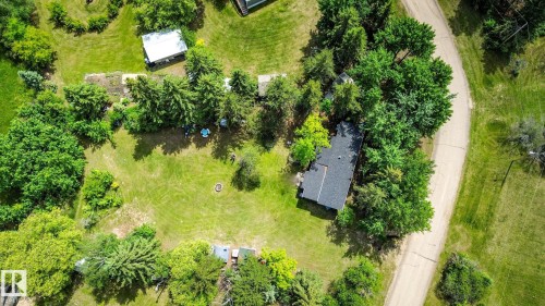 Expansive property featuring a curved access road, established trees, and a detached structure - 331 60417 Range Road 124, Rural St. Paul County, AB 