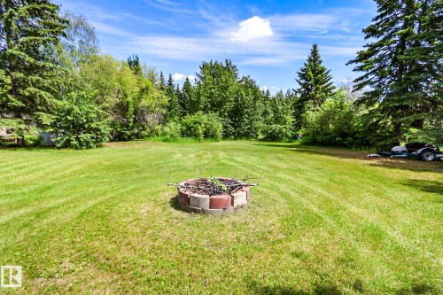 Expansive lawn area featuring a block-bordered fire pit - 331 60417 Range Road 124, Rural St. Paul County, AB 