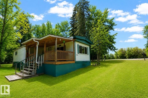 White siding exterior with a teal foundation and trim - 331 60417 Range Road 124, Rural St. Paul County, AB 
