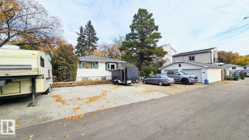 Residential property with a gray shingled roof, surrounded by mature trees - 12339 89 Street, Edmonton, AB - Outdoor With View
