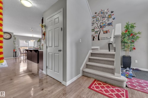 Staircase with carpeted treads and white banister - 5520 5 Avenue, Edmonton, AB - Indoor Photo Showing Other Room
