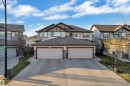 Contemporary duplex exterior featuring light-colored siding, dark trim accents, and a dual garage - 5520 5 Avenue, Edmonton, AB  - Outdoor With Facade 