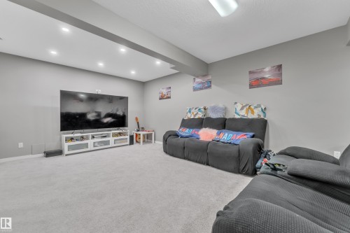 Spacious lower level featuring light gray carpeting, recessed lighting, and a neutral wall color - 5520 5 Avenue, Edmonton, AB - Indoor