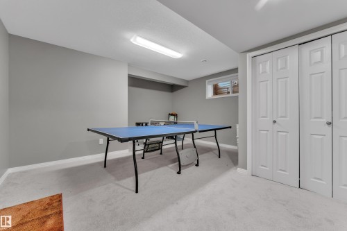 Finished room featuring light gray walls, white baseboards, and light gray carpeted flooring - 5520 5 Avenue, Edmonton, AB - Indoor Photo Showing Other Room