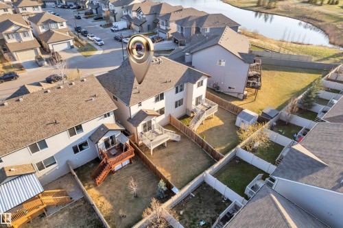 Rear exterior featuring a spacious fenced yard, two-tier wood deck, and a storage shed - 5520 5 Avenue, Edmonton, AB - Outdoor With View