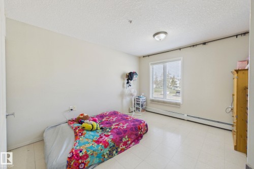 Spacious room featuring light-toned walls and hard-surface flooring - 220 80A Kelloway Crescent, Red Deer, AB - Indoor Photo Showing Bedroom