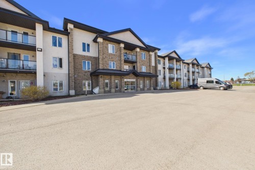 Modern multi-story building featuring brick and stucco facade - 220 80A Kelloway Crescent, Red Deer, AB - Outdoor With Balcony With Facade