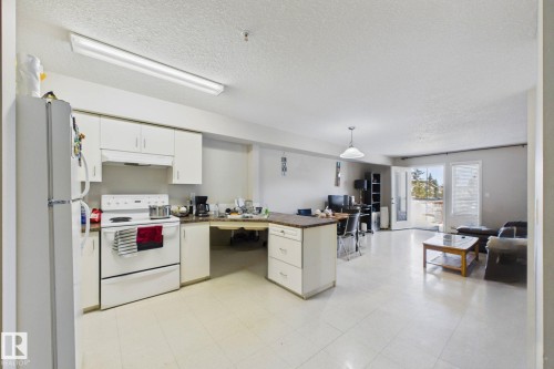 Open-concept living area with integrated kitchen - 220 80A Kelloway Crescent, Red Deer, AB - Indoor Photo Showing Kitchen