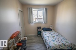 Compact room featuring light-toned walls and wood-finish flooring - 