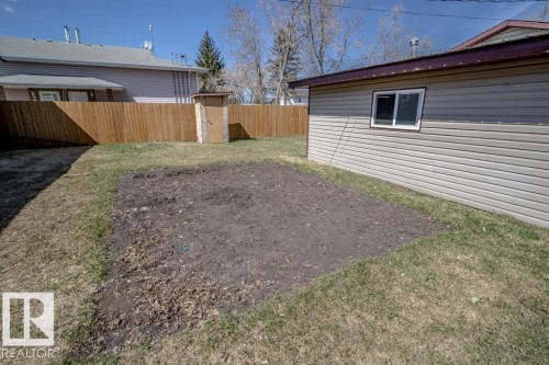Spacious rear yard featuring a large tilled garden area, a shed, and a privacy fence - 4822 45 Ave, St. Paul Town, AB - Outdoor