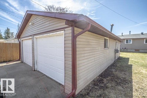 Detached two-car garage with light-colored siding and a brown roofline - 4822 45 Ave, St. Paul Town, AB - Outdoor With Exterior